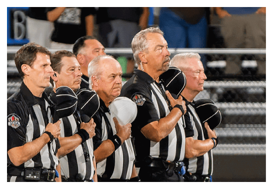 A group of people are kneeling on a field, possibly in a football game. AI generated content