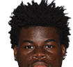 A young man wearing a white jersey with the number 10 on it. Description generated by AI