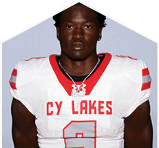 A young man wearing a white jersey with the number 10 on it. Description generated by AI
