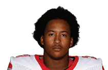 A young man wearing a white jersey with the number 10 on it. Description generated by AI