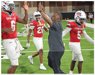 A group of football players celebrating a touchdown. Description generated by AI