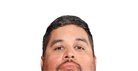 A person with short dark hair and a trimmed beard is looking directly at the camera against a white background. Description generated by AI