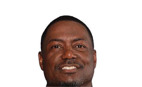 A person with short hair and a trimmed beard is smiling against a plain white background. Description generated by AI