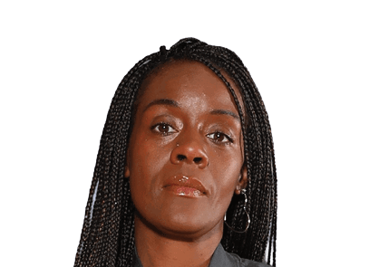 Person with long braided hair and hoop earrings looking directly at the camera with a neutral expression. Description generated by AI