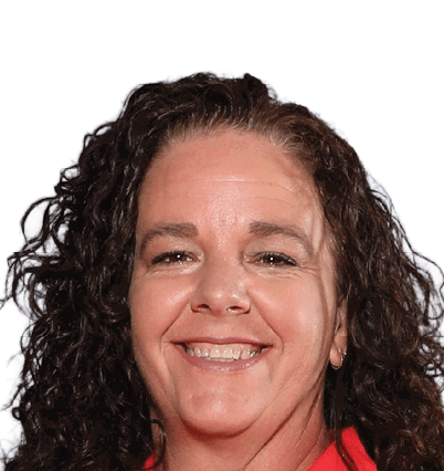 A person with curly hair is smiling and wearing a red top against a white background. Description generated by AI