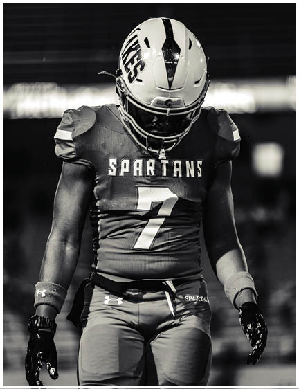 A football player wearing a blue jersey with the number 58 on it. Description generated by AI