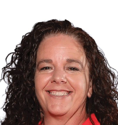 A person with curly hair is smiling and wearing a red top against a white background. Description generated by AI