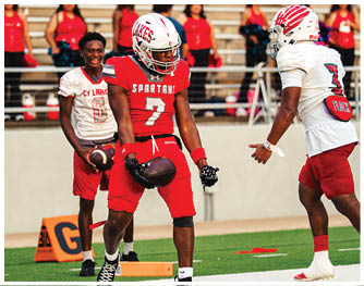 A group of football players celebrating a touchdown. Description generated by AI