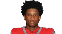 A young man wearing a white jersey with the number 10 on it. Description generated by AI