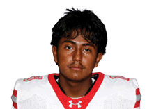 A young man wearing a white jersey with the number 10 on it. Description generated by AI