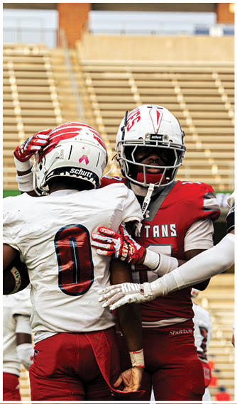A group of football players celebrating a touchdown. Description generated by AI