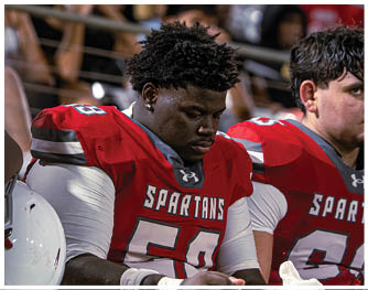 A group of football players celebrating a touchdown. Description generated by AI