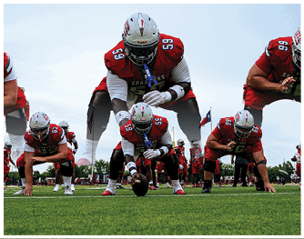 A group of football players celebrating a touchdown. Description generated by AI