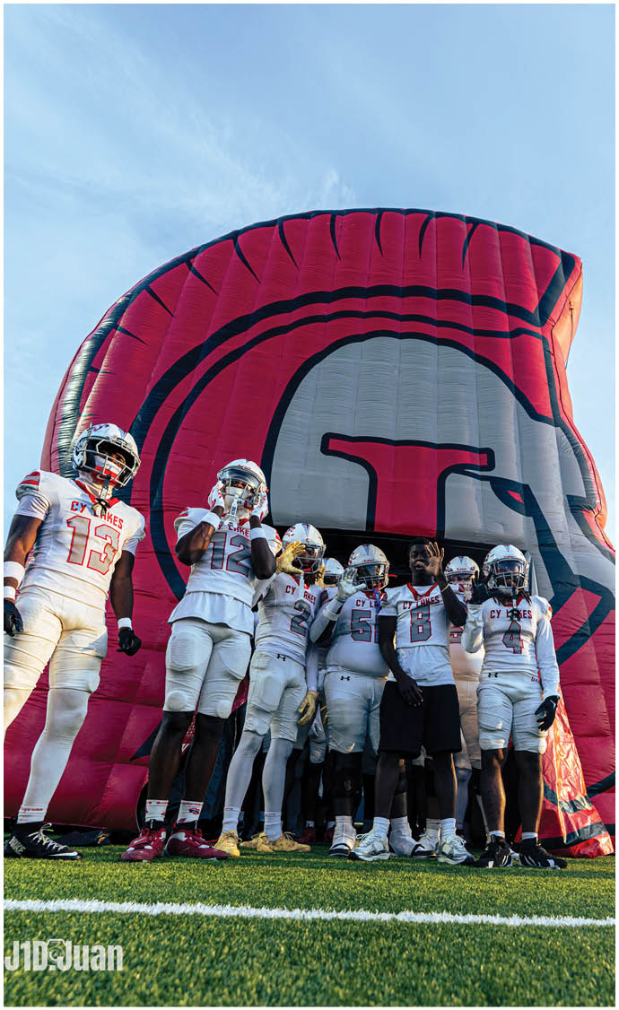 A group of football players on a field. Description generated by AI