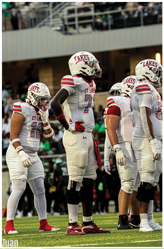 A group of football players celebrating a touchdown. Description generated by AI