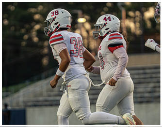 A group of football players celebrating a touchdown. Description generated by AI