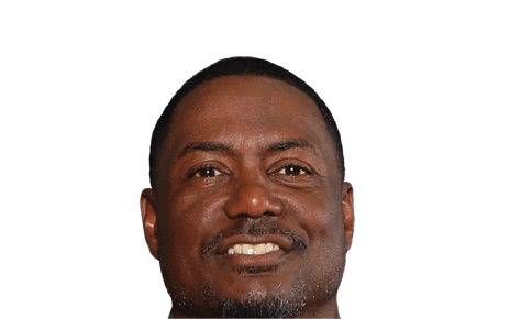 A person with short hair and a trimmed beard is smiling against a plain white background. Description generated by AI