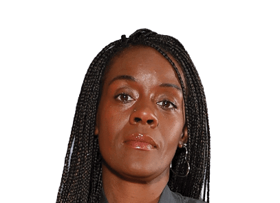 Person with long braided hair and hoop earrings looking directly at the camera with a neutral expression. Description generated by AI