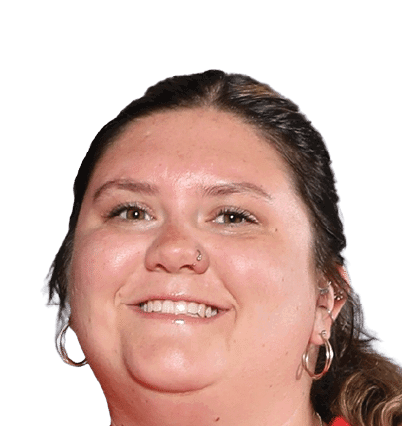 A person with long hair pulled back is smiling and wearing hoop earrings and a nose ring against a white background. Description generated by AI