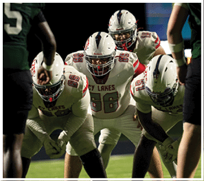 A group of football players celebrating a touchdown. Description generated by AI