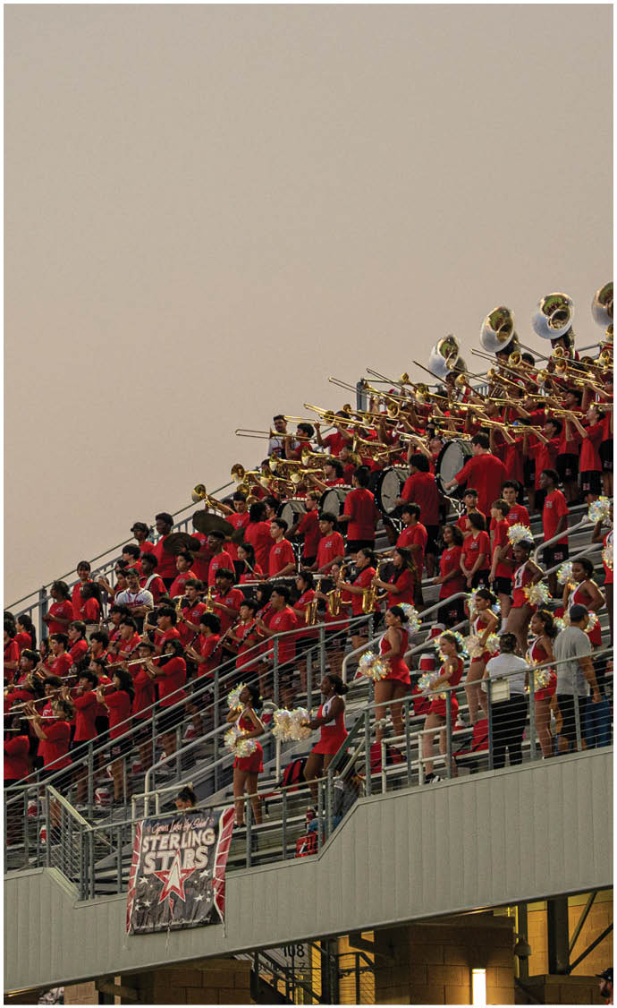 A group of football players on a field. Description generated by AI
