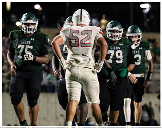 A group of football players celebrating a touchdown. Description generated by AI