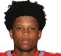 A young man wearing a white jersey with the number 10 on it. Description generated by AI