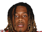 A young man wearing a white jersey with the number 10 on it. Description generated by AI