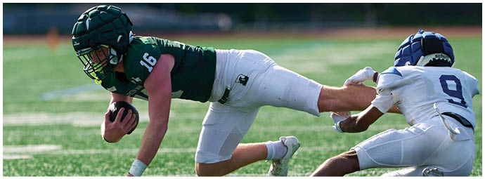 A group of football players on a field. Description generated by AI