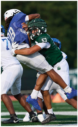 A football player catching a ball. Description generated by AI