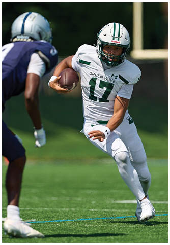 Two football players wearing blue and white uniforms. Description generated by AI