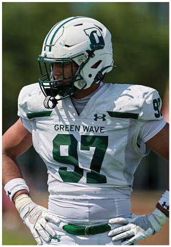 Two football players wearing blue and white uniforms. Description generated by AI