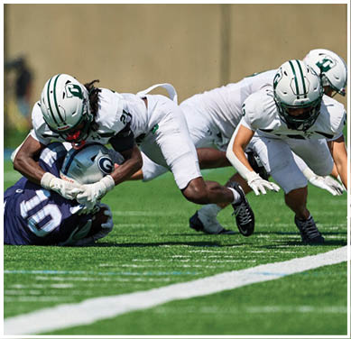 A football game is taking place with a group of men on the field. Description generated by AI