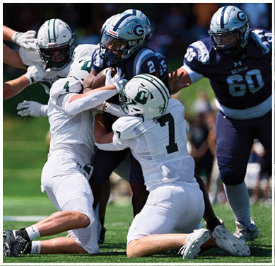 A football game is taking place with a group of men on the field. Description generated by AI