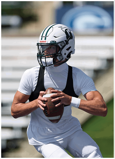 A football player wearing a blue and red jersey. Description generated by AI