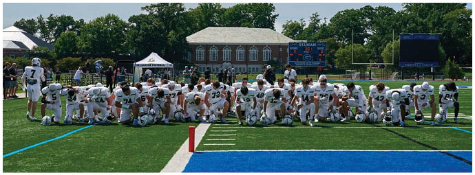 A football game is taking place with players on the field. Description generated by AI