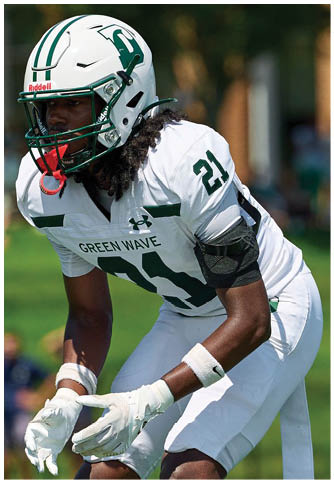 Two football players wearing blue and white uniforms. Description generated by AI