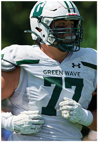 Two football players wearing blue and white uniforms. Description generated by AI
