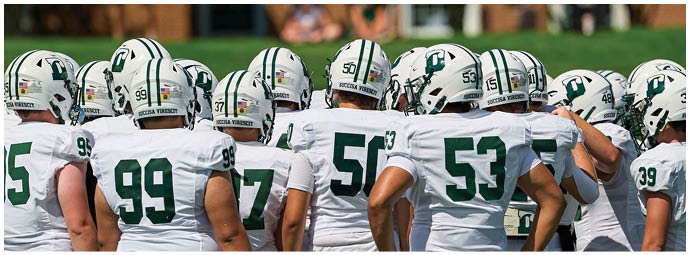 A football game is taking place with players on the field. Description generated by AI