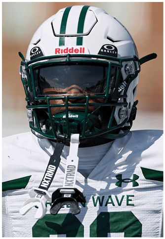 Two football players wearing blue and white uniforms. Description generated by AI