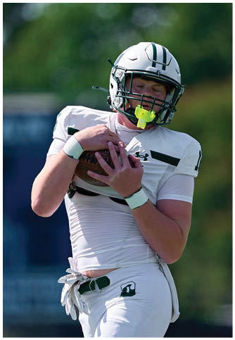 Two football players wearing blue and white uniforms. Description generated by AI
