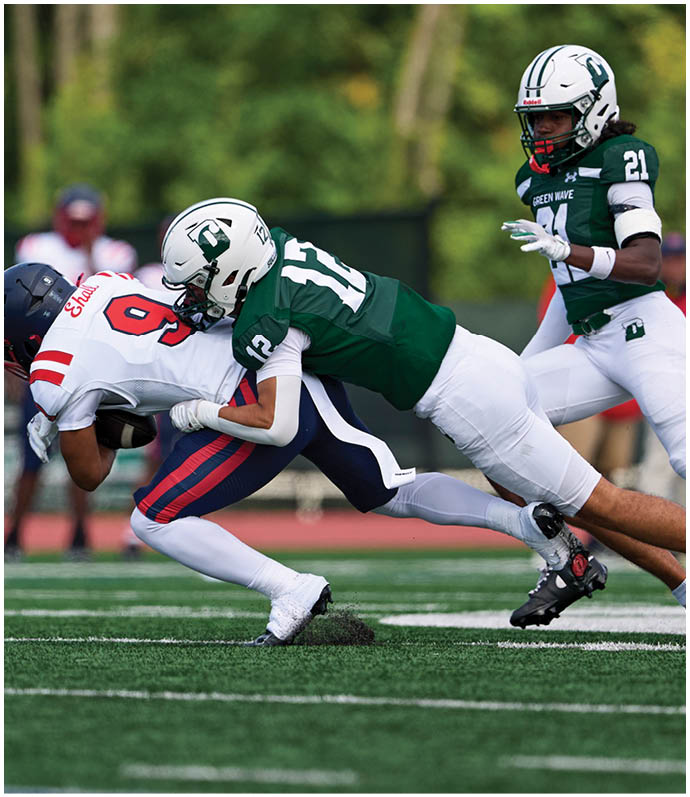 A football player wearing a blue and red jersey. Description generated by AI
