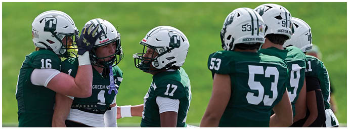 A football game is taking place with players on the field. Description generated by AI