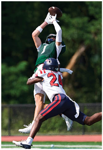 Two football players wearing blue and white uniforms. Description generated by AI