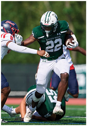Two football players wearing blue and white uniforms. Description generated by AI