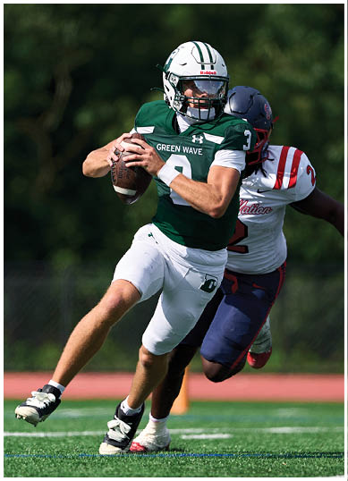 A football player wearing a blue and red jersey. Description generated by AI
