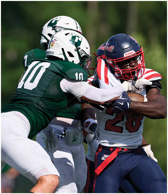 A football player wearing a blue and red jersey. Description generated by AI