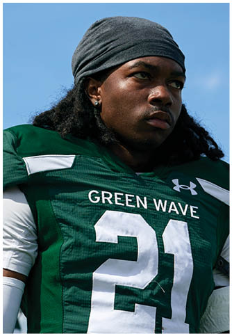 Two football players wearing blue and white uniforms. Description generated by AI