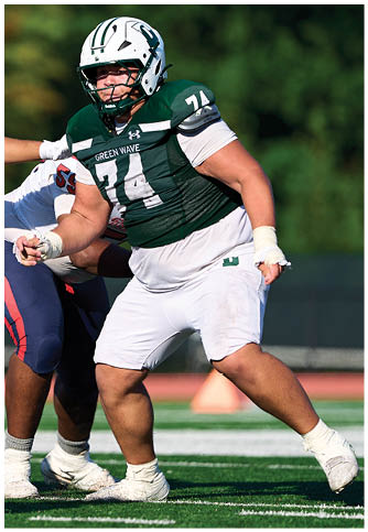Two football players wearing blue and white uniforms. Description generated by AI