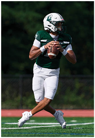 Two football players wearing blue and white uniforms. Description generated by AI